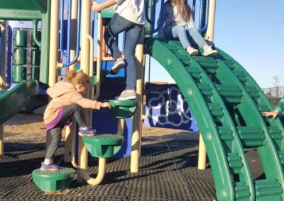 rubber mats on a playground with children playing