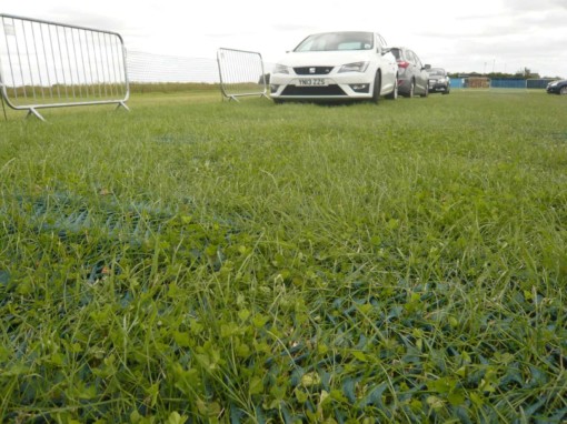 cars parked on grass over ground protection mesh