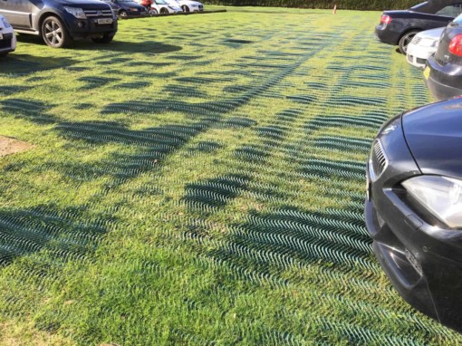 heavy duty ground protection mesh used as reinforcement for a parking lot on grass