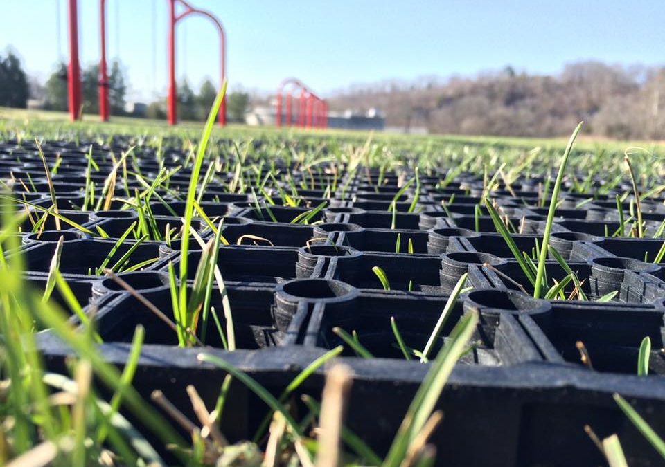 close up of rubber grass mat with grass barely growing through