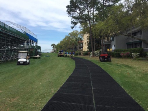 grass mats on a golf course with golf carts nearby