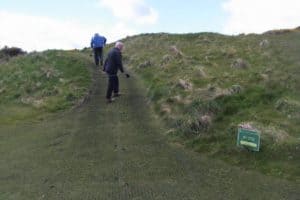 golfer standing on golf cart path