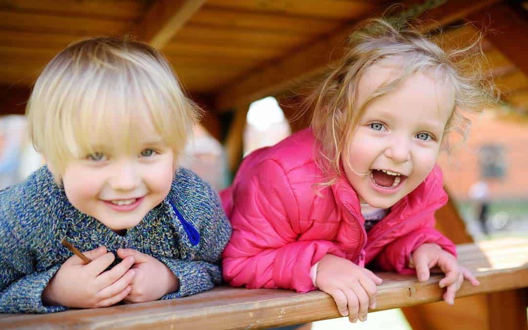 two children playing on a daycare playground