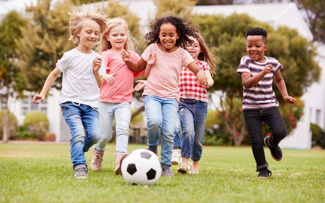 kids playing on grass that is protected by grass mats