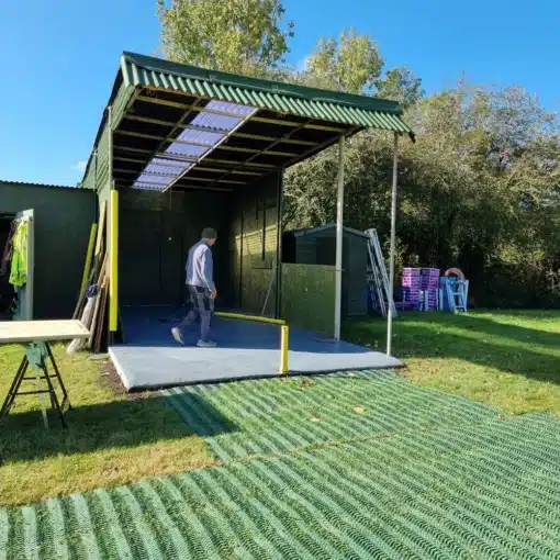 grassmats over healthy grass leading to an outdoor structure